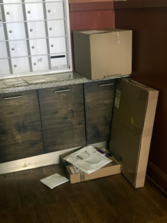 Packages delivered to apartment building lobby, Brooklyn, New York, USA