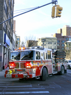 New York City Fire Department truck turning on street corner, Brooklyn, New York, USA