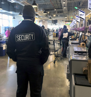 Security guard at self-checkout, Whole Foods Market, Williamsburg, Brooklyn, New York, USA