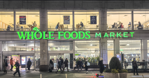 Whole Foods Market, building exterior and sidewalk scene at night, New York City, New York, USA