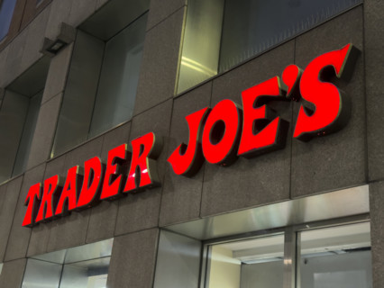 Trader Joe's grocery store, building exterior with company sign at night, New York City, New York,