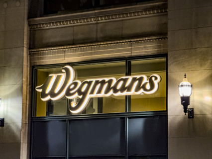 Wegman's, store logo on building exterior at night, low angle view of company sign, New York City,