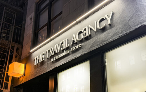 The Travel Agency, a Cannabis Store, building exterior at night, New York City, New York, USA