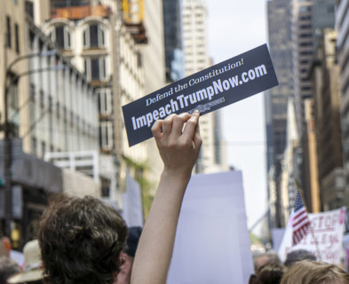 Demonstrators participating in "Our City, Our Fight: Protect Migrants, Protect the Planet" protest,