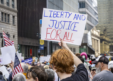 Demonstrators participating in "Our City, Our Fight: Protect Migrants, Protect the Planet" protest,