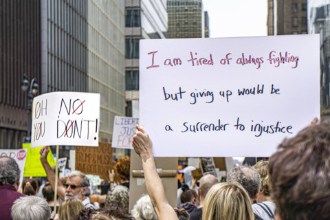Demonstrators participating in "Our City, Our Fight: Protect Migrants, Protect the Planet" protest,