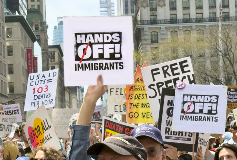 Demonstrators participating in "Our City, Our Fight: Protect Migrants, Protect the Planet" protest,