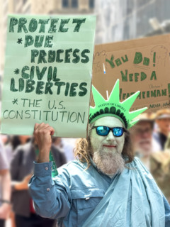 Demonstrators participating in "Our City, Our Fight: Protect Migrants, Protect the Planet" protest,