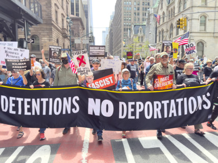 Demonstrators participating in "Our City, Our Fight: Protect Migrants, Protect the Planet" protest,