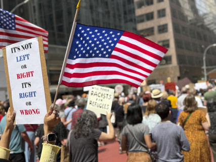 Demonstrators participating in "Our City, Our Fight: Protect Migrants, Protect the Planet" protest,