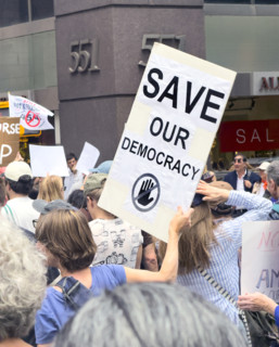 Demonstrators participating in "Our City, Our Fight: Protect Migrants, Protect the Planet" protest,