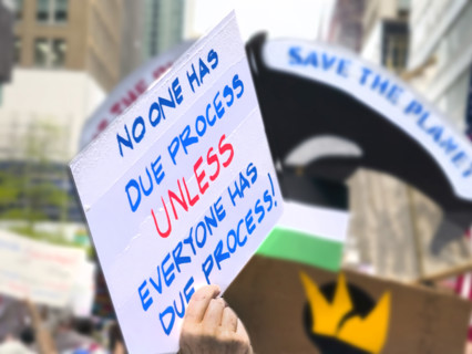 Demonstrators participating in "Our City, Our Fight: Protect Migrants, Protect the Planet" protest,