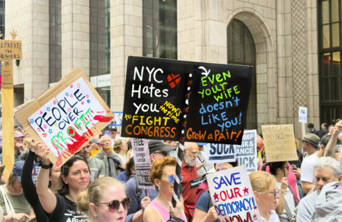 Demonstrators participating in "Our City, Our Fight: Protect Migrants, Protect the Planet" protest,