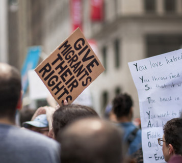 Demonstrators participating in "Our City, Our Fight: Protect Migrants, Protect the Planet" protest,