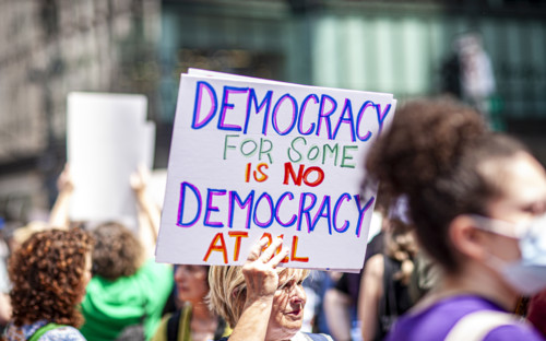 Demonstrators participating in "Our City, Our Fight: Protect Migrants, Protect the Planet" protest,