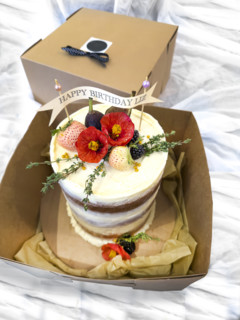 Pistachio birthday cake with buttercream frosting and edible flowers