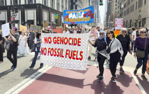 Demonstrators participating in "Our City, Our Fight: Protect Migrants, Protect the Planet" protest,