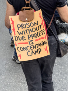 Demonstrator participating in "Our City, Our Fight: Protect Migrants, Protect the Planet" protest,
