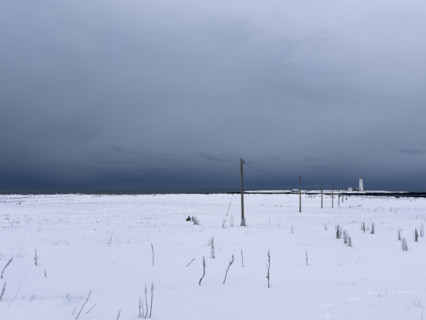 Snowy field with dramatic gray sky