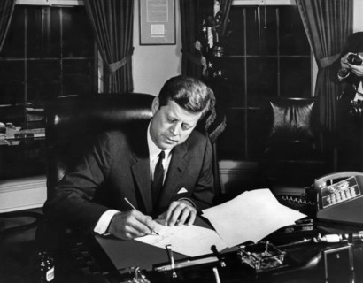 U.S. President John F. Kennedy signing the Interdiction of the Delivery of Offensive Weapons to