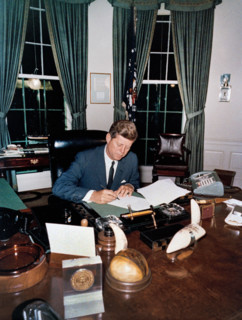 U.S. President John F. Kennedy signing the Interdiction of the Delivery of Offensive Weapons to