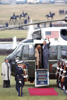 U.S. President Richard M. Nixon and U.S. First Lady Pat Nixon wave from helicopter door as they