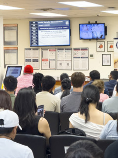 Group of people sitting in waiting area of U.S. Social Security Administration Office, New York City
