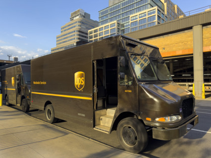 UPS delivery trucks parked on street, New York City
