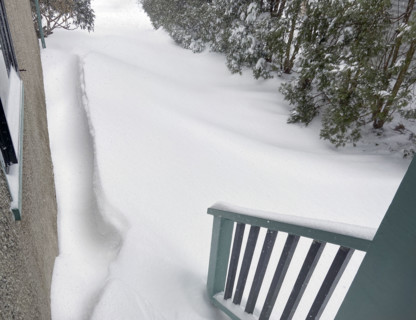 View of snowdrifts from back porch of residential home