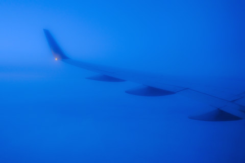 Commercial airplane wing viewed from passenger window