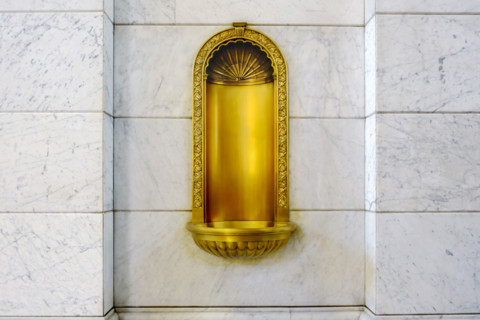Gilded niche recessed in marble wall