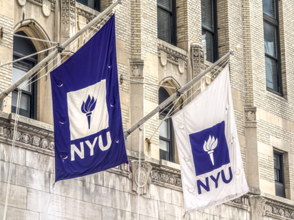 Two NYU flags flying above entrance to Frederick Loewe Theatre, New York University, 35 West 4th