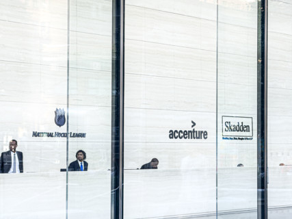 Lobby view with signs for offices of National Hockey League, Accenture, Skadden, Arps, Slate,