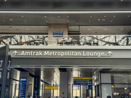Direction sign for Amtrak Metropolitan Lounge, Moynihan Train Hall, Pennsylvania Station,
