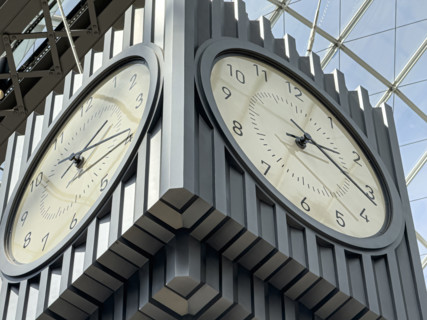 Hanging 4-sided clock above passenger concourse low angle view, Moynihan Train Hall, Pennsylvania