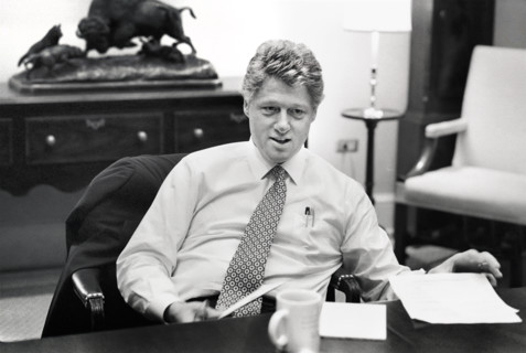 U.S. President Bill Clinton sitting at  conference table during meeting in the White House,
