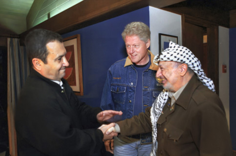 Israeli Prime Minister Ehud Barak and Palestinian Authority Chairman Yasser Arafat shaking hands as