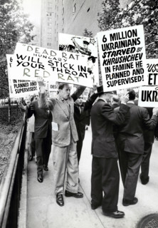 Group of people with signs protesting Soviet Leader Nikita Khrushchev's visit to United Nations,