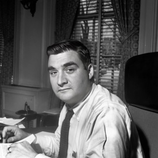 U.S. Press Secretary Pierre Salinger sitting in his office in the White House, Washington, D.C.,