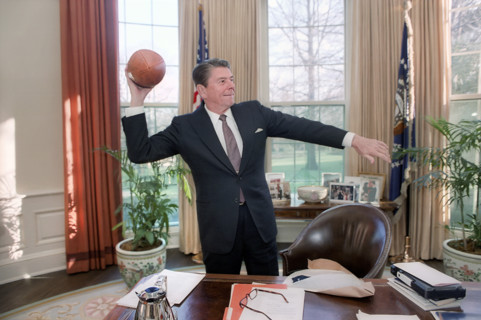 U.S. President Ronald Reagan throwing a USC football in the Oval Office of the White House,
