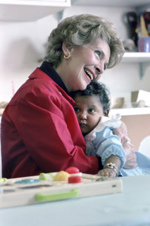 US. First Lady Nancy Reagan holding child while visiting Columbia Presbyterian Medical Center,