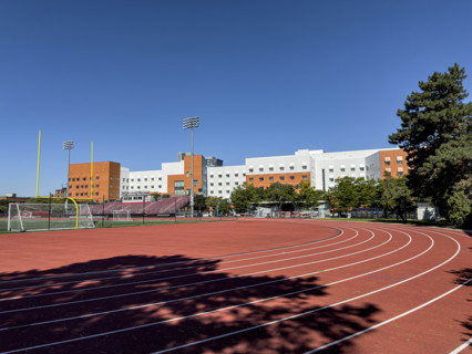 Running track and athletics field with New Vassar undergraduate dormitory in background,