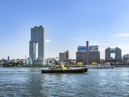 Circle Line ferry and tugboat in East River against Williamsburg cityscape, Brooklyn, New York