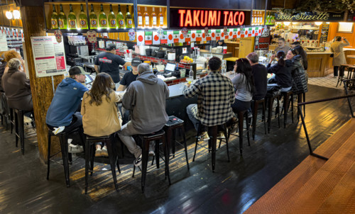 Group of people eating at casual restaurant, Takumi Taco, Chelsea Market, Ninth Avenue, Chelsea,