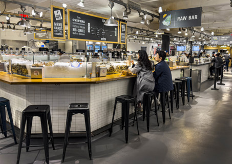 Two people eating at casual restaurant, Lobster Place fish store and restaurant, Chelsea Market,