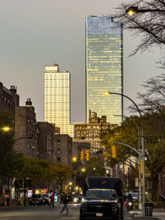 Street scene at dusk, Ninth Avenue at 16th Street, looking north to Hudson Yards, Manhattan, New