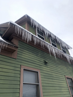 Icicles hanging from rooftop