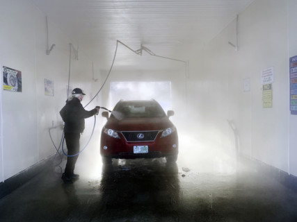 Man washing car at self-service car wash