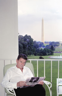 U.S. President Ronald Reagan reading Washington Star newspaper on the Truman balcony, White House,