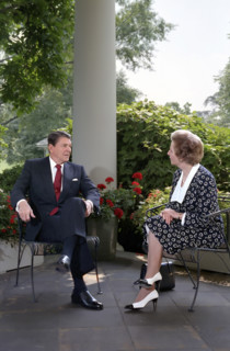 U.S. President Ronald Reagan and British Prime Minister Thatcher talk on patio outside White House